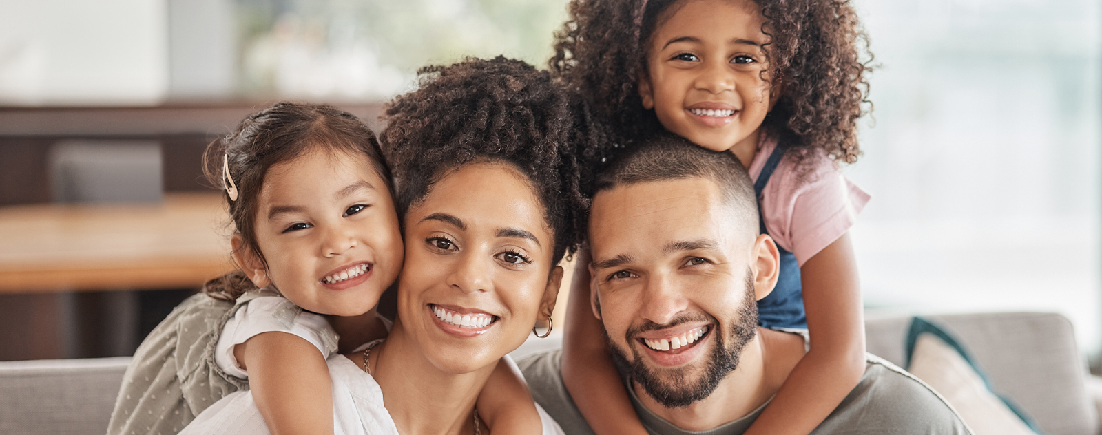 happy-smile-portrait-interracial-family-sitting-sofa-living-room-home-happiness-love-adoptive-parents-bonding-embracing-relaxing-with-their-children-lounge